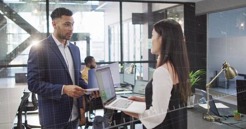 Colleagues Collaborating and Sharing Ideas in Open Plan Office