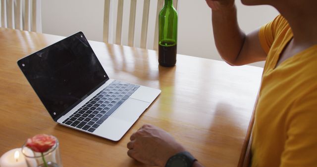 Person Sitting at Table Using Laptop and Drinking Beverage - Download Free Stock Images Pikwizard.com