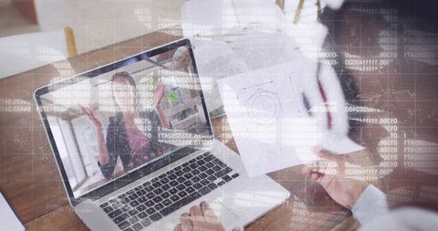 Remote team collaborating on laptop with presenter gesturing and colleague holding diagram