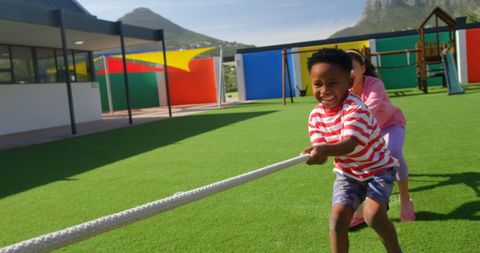 Kids Playing Tug of War on Playground Grassy Field