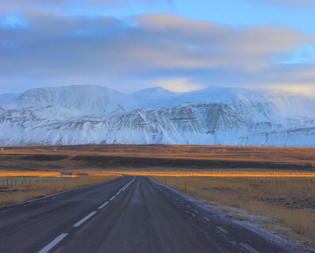 Endless Road Leading to Snow-Capped Mountains at Sunset - Download Free Stock Photos Pikwizard.com