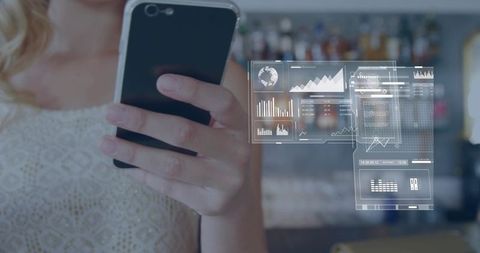 Young woman holding smartphone viewing augmented reality analytics holographic dashboards