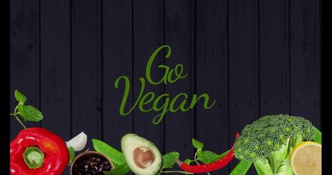 Go vegan rustic dark wood banner with fresh avocado, broccoli, red pepper, lemon