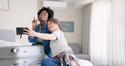 Lesbian Couple Selfie While Packing for Vacation Excitement