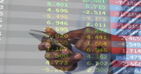Hand Holding Smartphone Against Flowing Stock Market Data Display