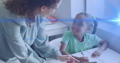 Teacher Connecting with Student Through Technology in Classroom