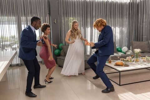 Diverse Guests Dancing With Bride and Groom in Modern Living Room