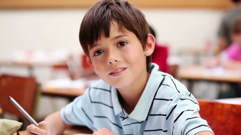 Happy Student Writing in Classroom Setting