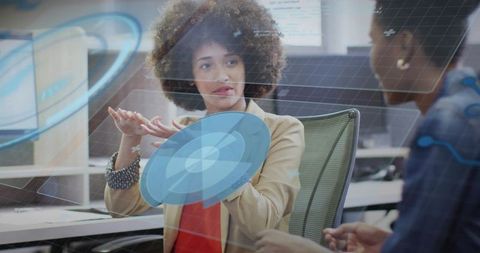 Woman demonstrating augmented reality holographic interface during office team presentation