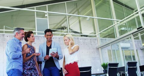Professional Collaboration Around Tablet in Modern Office Setting