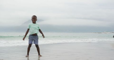 Joyful Child Performing Cartwheel on Sandy Beach