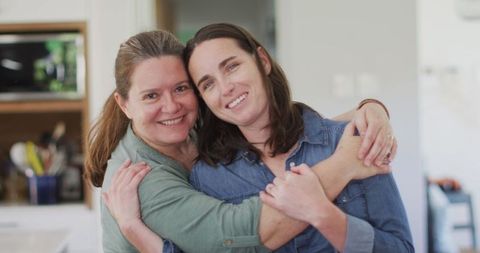 Happy Lesbian Couple Embracing at Home
