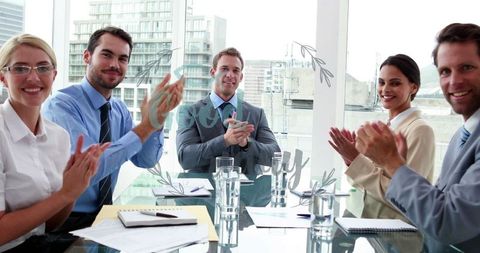 Business Team Clapping and Celebrating Success in Modern Office
