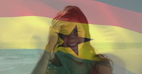 Smiling woman on ghana coastline with flag overlay for beach travel lifestyle