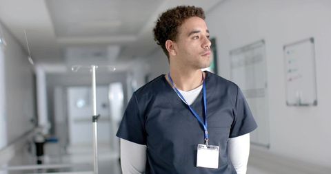 Confident Healthcare Worker in Modern Hospital Hallway