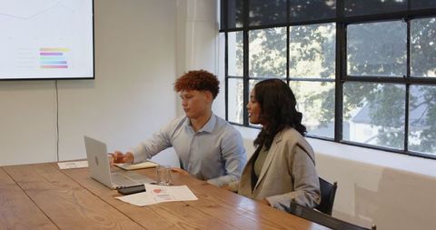 Diverse team analyzing digital trends during corporate meeting