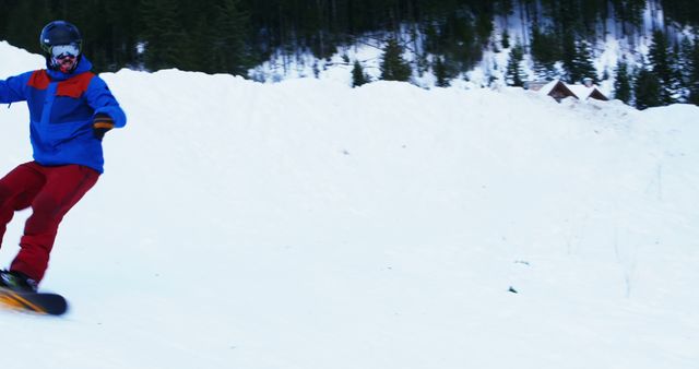Person snowboarding on snowy mountain slope