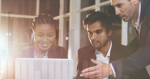 three colleagues focusing on a laptop screen, engaging in financial analysis. the digital overlay of graphs and charts emphasizes the integration of technology in modern business practices. suitable for illustrating themes of teamwork, diversity in the workplace, global finance collaboration, and technology-driven strategies in corporate settings.