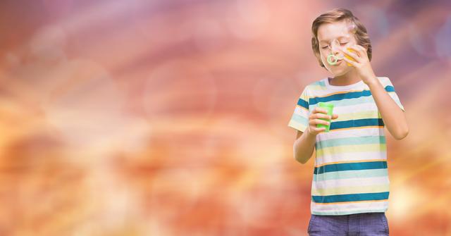 Digital composite of Little boy playing with bubbles over blurred background