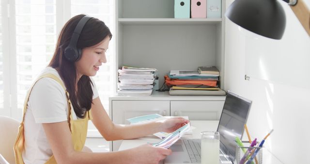 Young Woman Studying at Home with Laptop and Headphones - Download Free Stock Images Pikwizard.com