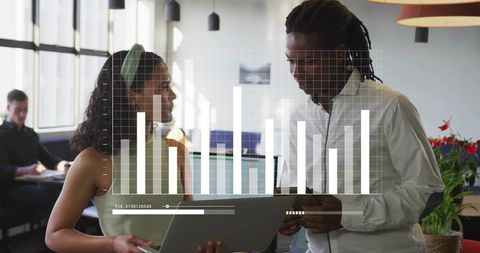 Team Discussing Data with Laptop and Bar Chart in Coworking Office