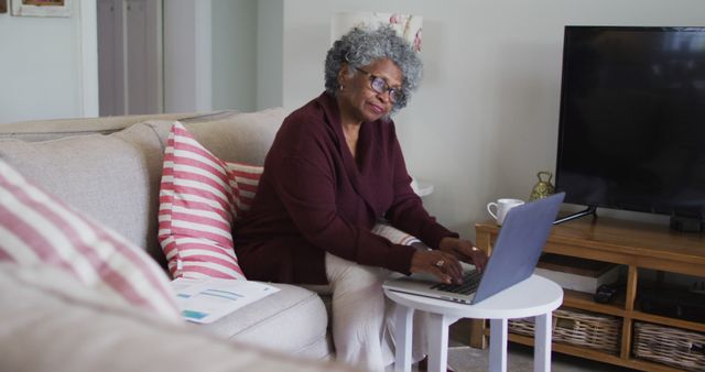 Senior Woman Using Laptop on Couch in Cozy Home Setting - Download Free Stock Images Pikwizard.com