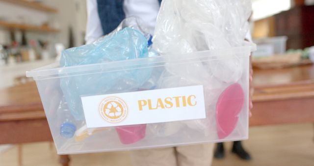 Person Holding Plastic Recyclables Container for Environmental Awareness - Download Free Stock Images Pikwizard.com