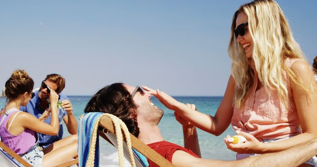 Friends Enjoying Beach Vacation Applying Sunscreen - Download Free Stock Images Pikwizard.com