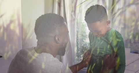 expresses the joy and connection between a father and son spending quality time at home. perfect for representing family values, parent-child relationships, and indoor bonding moments. useful for campaigns on family importance, togetherness, parenting, and home life balance.