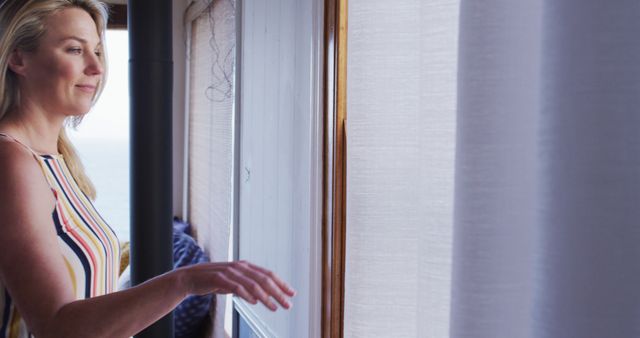 Woman Opening Curtains at Home with Natural Light - Download Free Stock Images Pikwizard.com