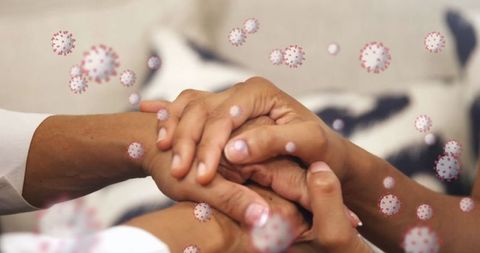 Hands with virus particles symbolizing unity in pandemic