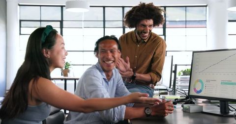 Diverse Team Enjoying Successful Collaboration in Modern Office
