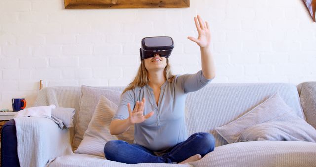 Woman Experiencing Virtual Reality on Couch with VR Headset - Download Free Stock Images Pikwizard.com