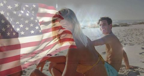 Young friends celebrating summer on sunny beach with american flag overlay, patriotic vacation