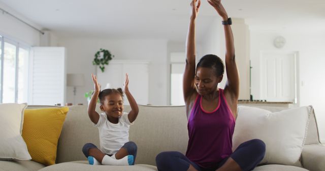 Mother and Daughter Enjoying Yoga Together on Sofa at Home - Download Free Stock Images Pikwizard.com