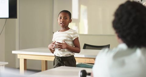 African american teen girl giving classroom presentation showing confidence and engagement