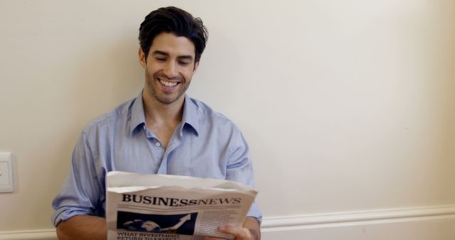 Portrait of smiling man reading business newspaper at home 4k