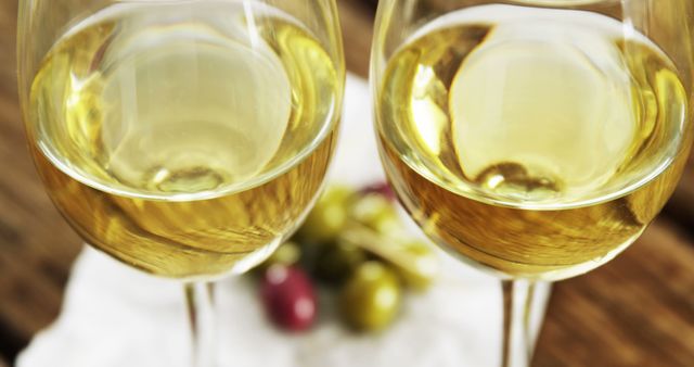 Close-Up of Two Glasses of White Wine with Grapes - Download Free Stock Images Pikwizard.com