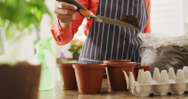 Gardener Working with Soil and Pots Indoors - Download Free Stock Images Pikwizard.com