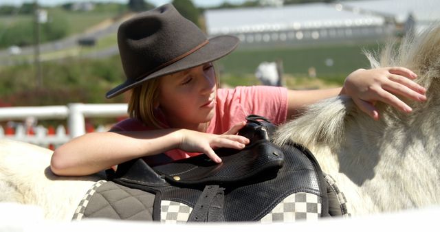 Young Girl Adjusting Horse Saddle Outdoors - Download Free Stock Images Pikwizard.com