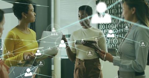 Women Collaborating on Digital Network Strategy and Teamwork in Modern Office Meeting