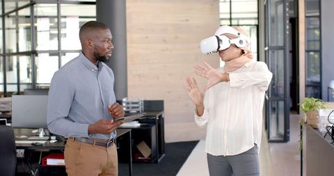 Diverse team embracing virtual reality technology in modern office