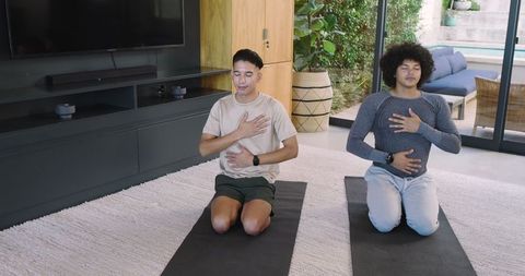 Two friends practicing mindful breathing at home