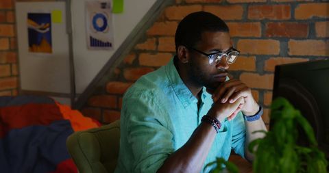 Focused Businessman Analyzing Data on Computer in Stylish Office