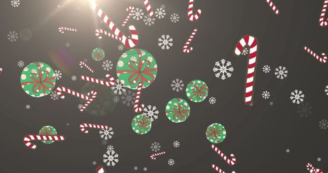 Festive holiday candies and snowflakes on grey