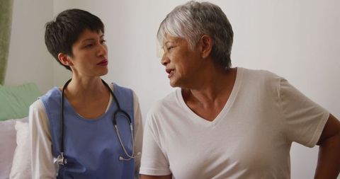 Senior Woman Consulting with Doctor in Retirement Home Setting