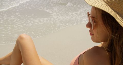 Peaceful Beachside Relaxation with Woman in Sun Hat