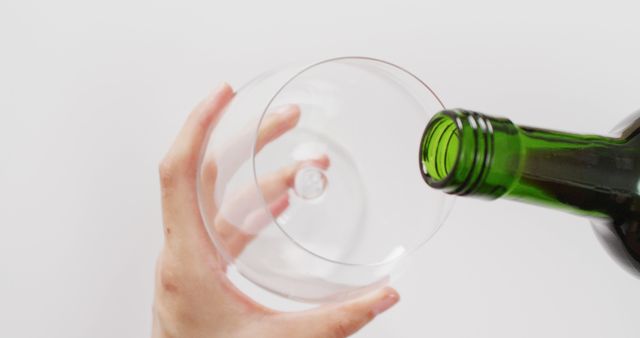 Woman Hand Pouring Wine into Glass Against White Background - Download Free Stock Images Pikwizard.com