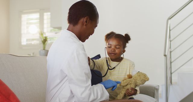 Pediatrician using stethoscope with young patient playing doctor - Download Free Stock Images Pikwizard.com