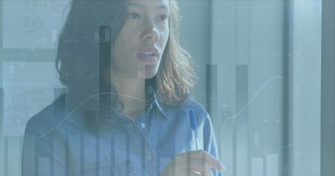 Businesswoman analyzing data visualizations in office